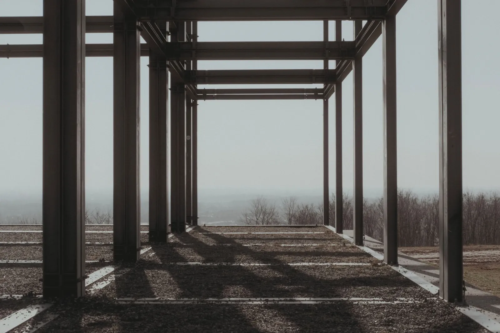 Steel columns and beams erected on a concrete slab before the roof framing goes on.