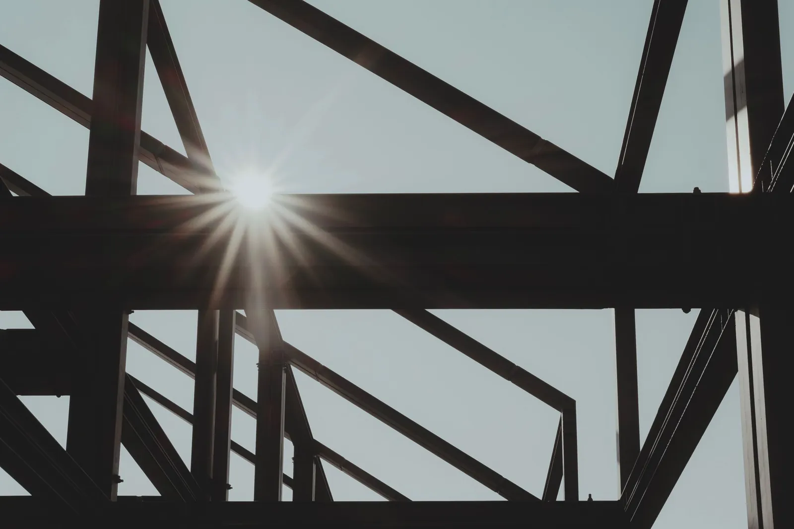 Structural steel beams and bracing of a building frame against the sun during erection.